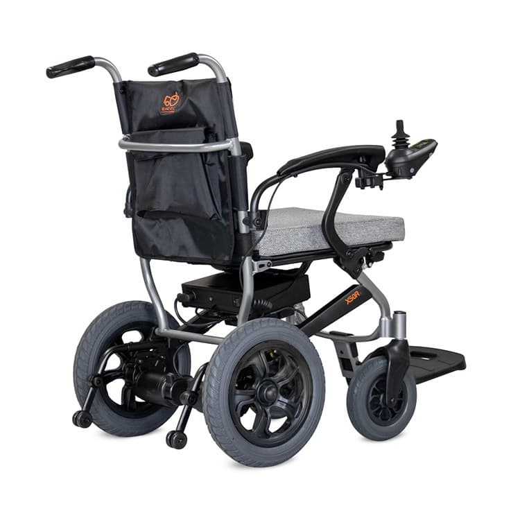 Excel X50R elektrische rolstoel met brede centrale voetsteun, heupgordel en joystick bediening en zwart en zilver frame met lichtgrijze bekleding zijachteraanzicht anti-kiepwielen en tasje